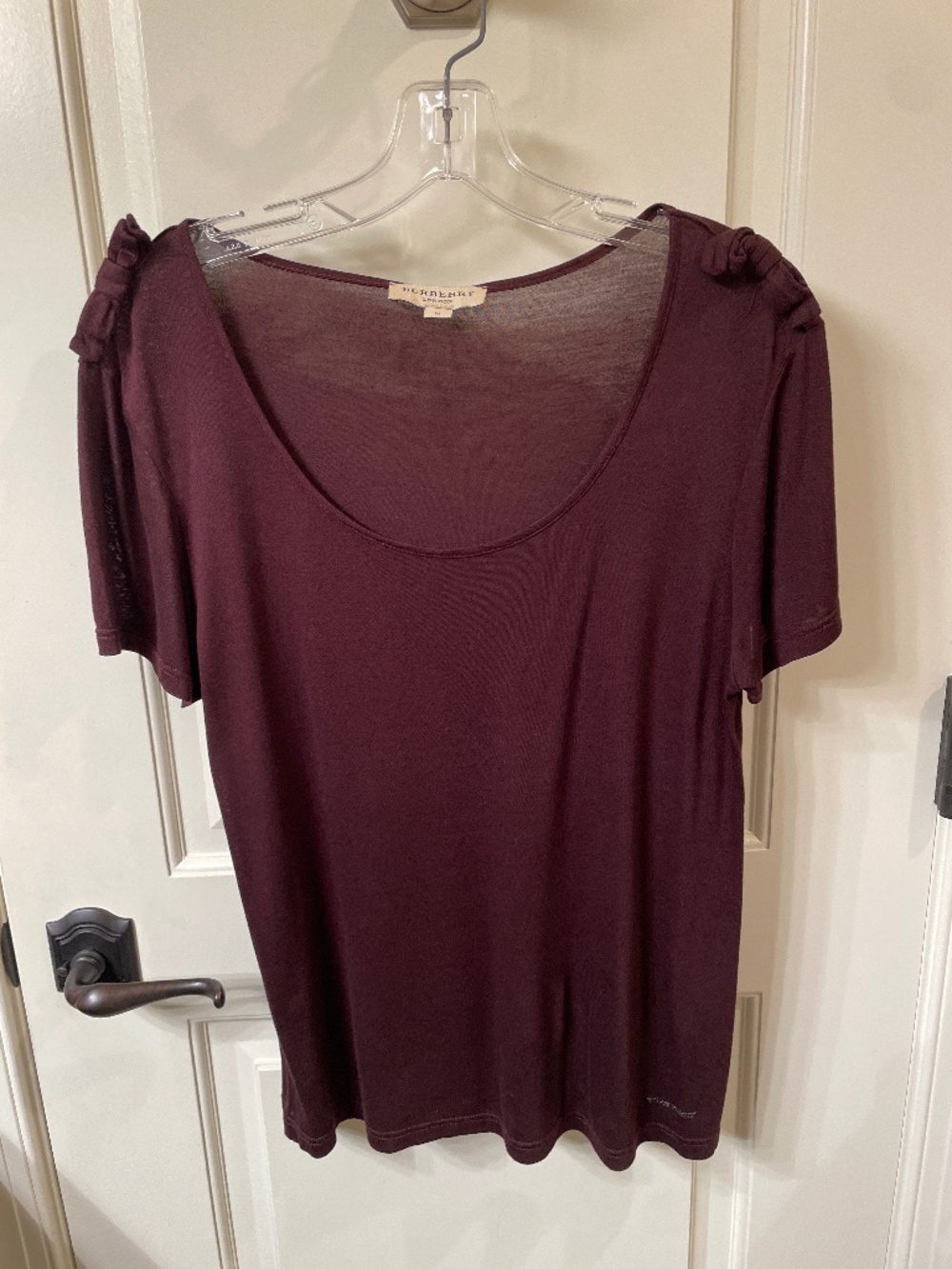 Burberry plum short sleeve top with bow accents.